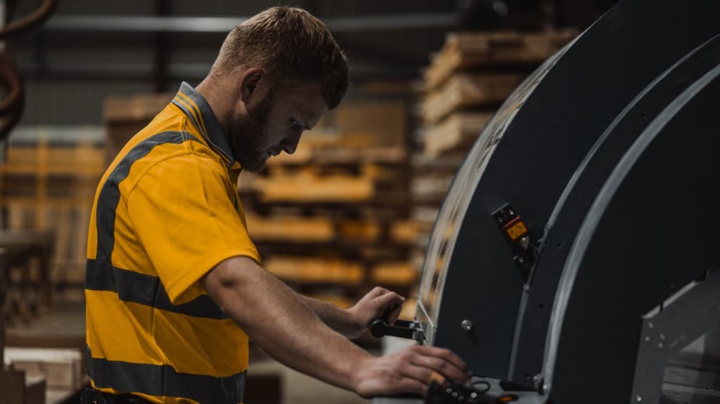 Industrial circular saw cutting timber beam